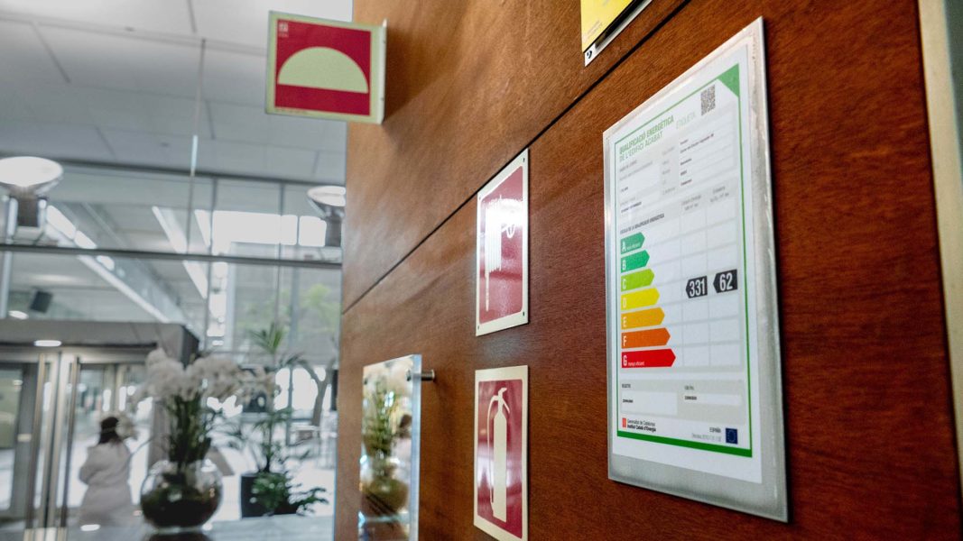 Vestíbulo del PRBB con certificado de eficiencia energética visible, con calificación D.