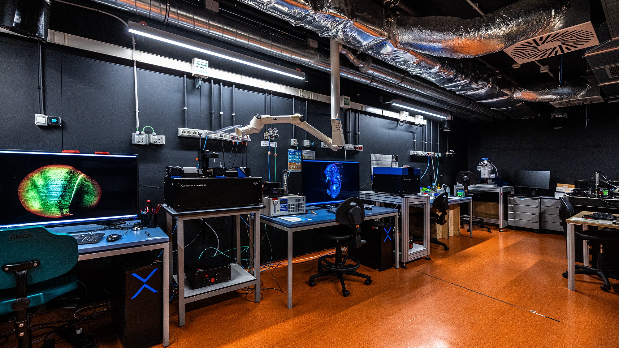 Dark room at EMBL Barcelona’s MIF, with three light-sheet microscopy systems used to obtain three-dimensional images of biological samples.